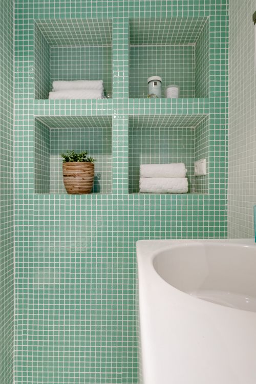 Bathroom with green mosaic tiles used to illustrate an imaginary nature retreat