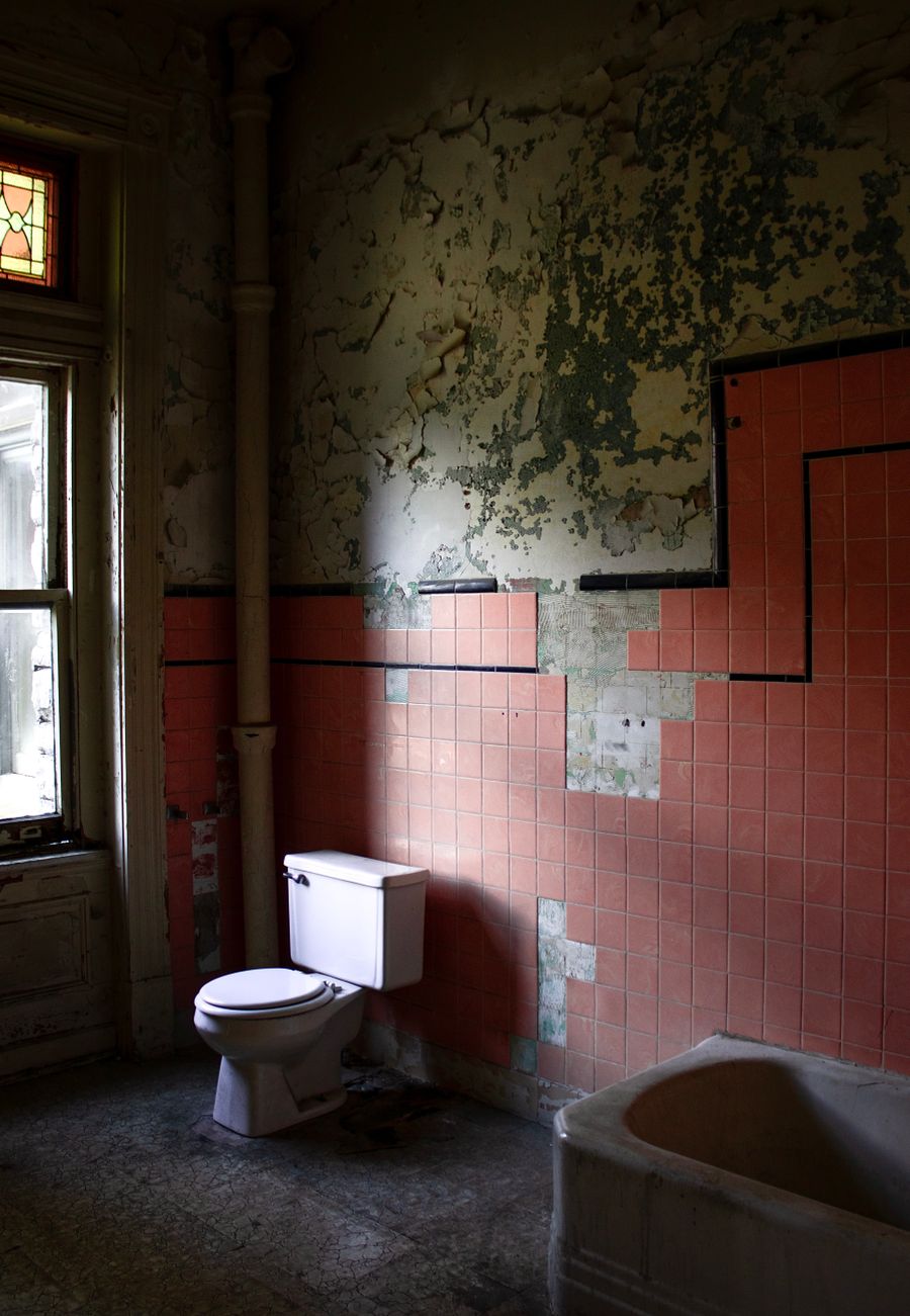 Weathered abandoned bathroom used to illustrate a deliberately bad fictional listing